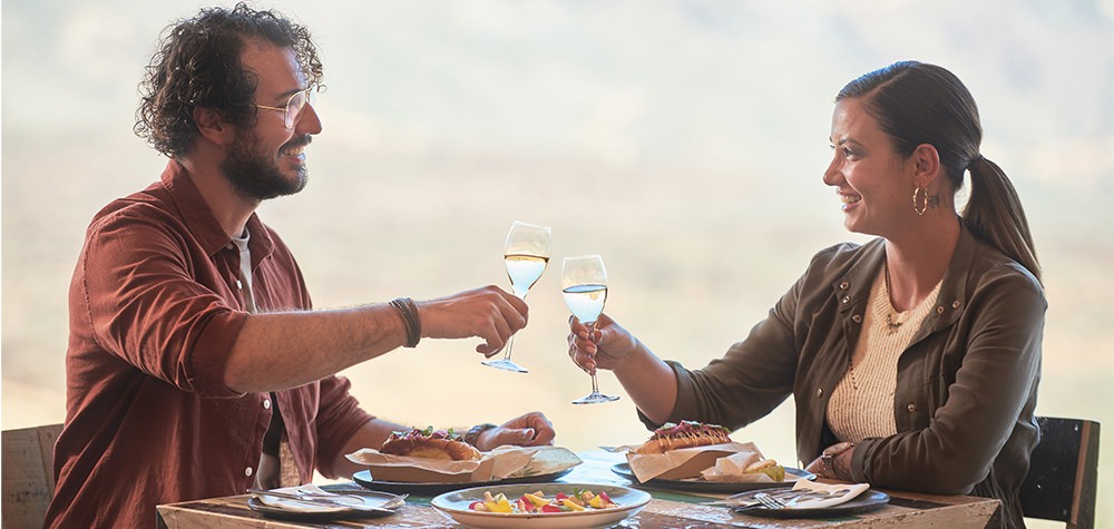 Couple making a toast during brunch in Tenerife on Teide