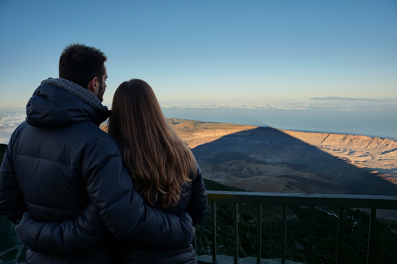 Couple watching the spectacle of the shadow of the Teide from the terrace viewpoints after riding the cable car
